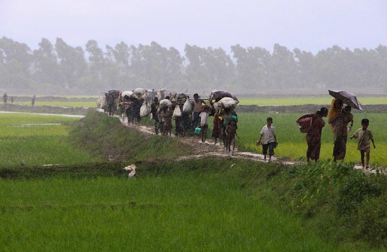 Rohingya refugees from Rakhine state in Myanmar walk along a path near Teknaf in Bangladesh on September 2, 2017.
Around 400 people -- most of them Rohingya Muslims -- have died in violence searing through Myanmar's Rakhine state, the army chief's office said on September 1, with tens of thousands forced to flee across the border into Bangladesh. A further 20,000 Rohingya have massed along the Bangladeshi frontier, barred from entering the South Asian country, while scores of desperate people have drowned attempting to cross the Naf, a border river, in makeshift boats.
 / AFP PHOTO / Suzauddin RUBEL        (Photo credit should read SUZAUDDIN RUBEL/AFP/Getty Images)
