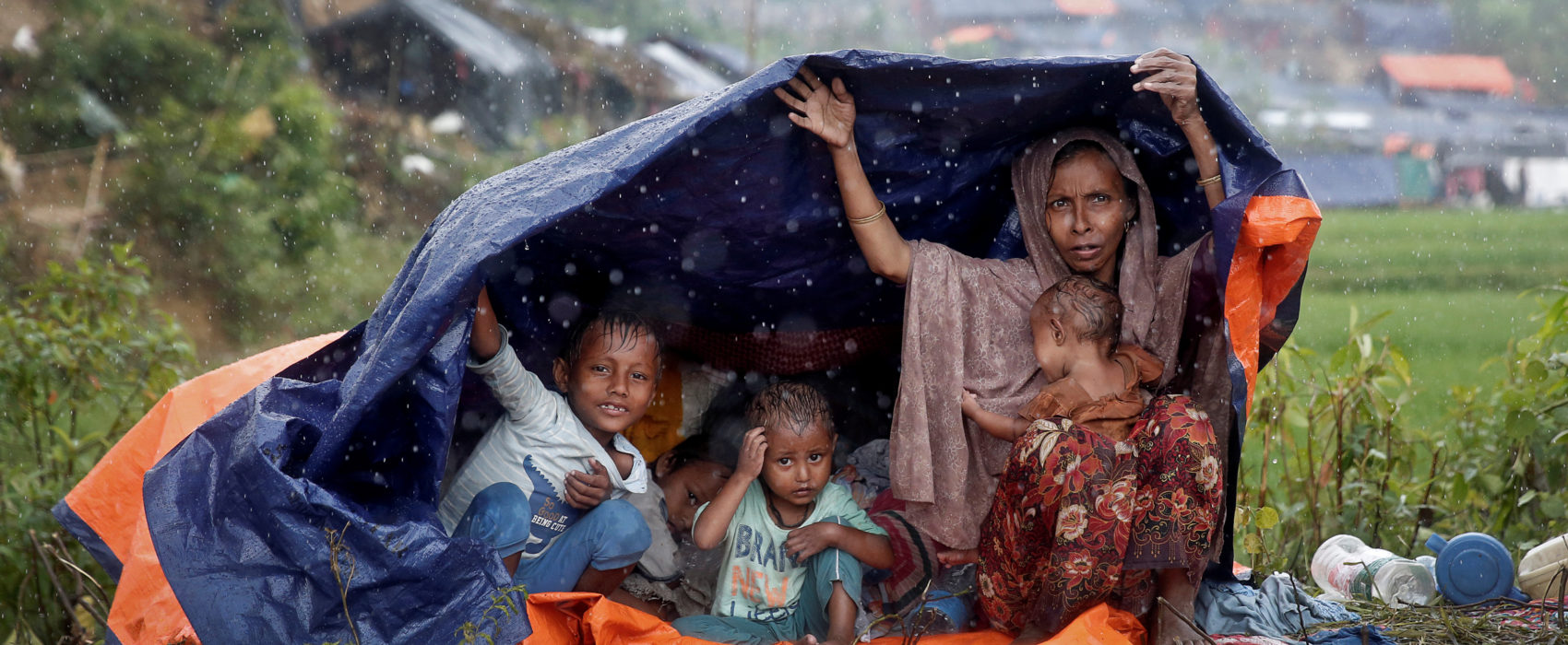 Rohingya refugees shelter from the rain in a camp in Cox's Bazar, Bangladesh, September 17, 2017. REUTERS/Cathal McNaughton - RC14DC744C10