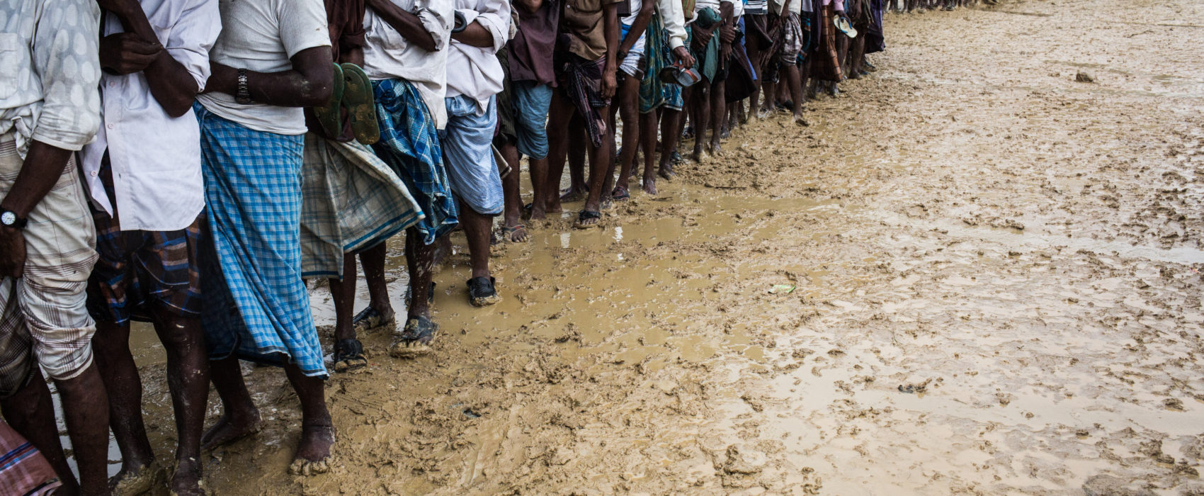 In the pouring rain, Rohingya refugees queue for hours, waiting for an aid distribution, Bangladesh, 28 September 2017. More than 520,000 Rohingya have fled the Myanmar military's campaign of violence in the span of seven weeks, which has led to an unfolding humanitarian crisis in Bangladesh. Many arrive without having eaten for days or weeks while trying to flee the military's violence in Myanmar.