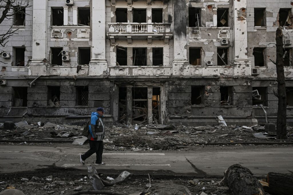A man walks in front of a police station destroyed by shelling in Kharkiv on March 25, 2022, during Russia's military invasion launched on Ukraine. - Russian strikes targeting a medical facility in Kharkiv on March 25, 2022, killed at least four civilians and wounded several others, Ukrainian officials said.