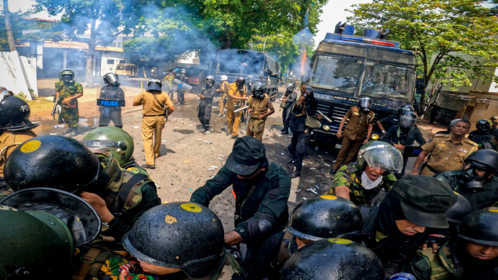 Sri Lankan police fire tear gas as anti-government protesters try to go through STF police in front of prime minister's office, Colombo, Sri Lanka. 13 July 2022