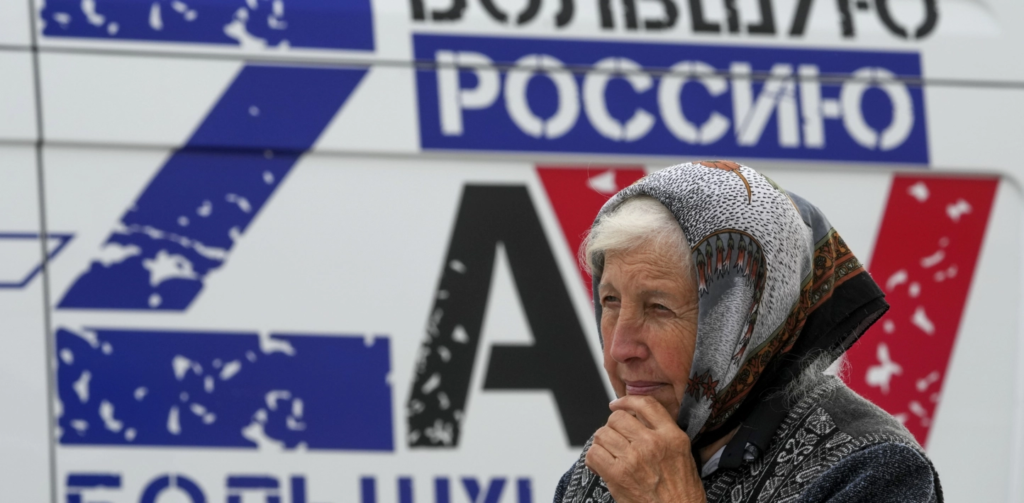 Older woman in Ukraine watches the Russian sham referenda in Ukraine unfold