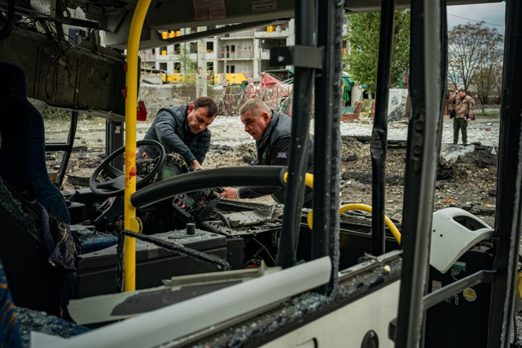 Workers deal with the aftermath of the Russian shelling in Kyiv