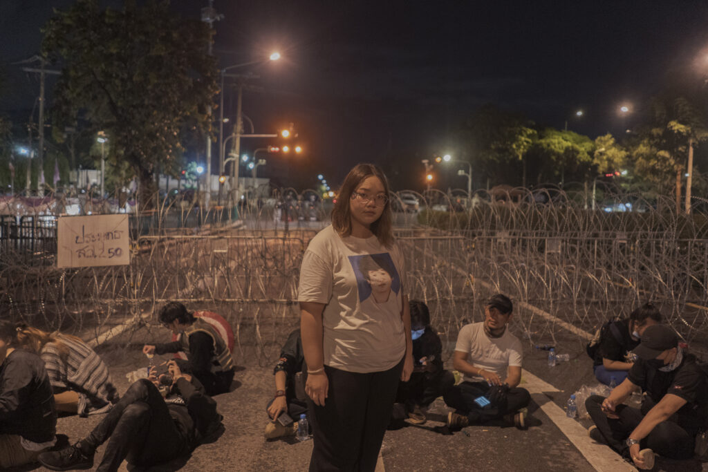 Panusaya Sithijirawattanakul, known as Rung, is a 22-year-old Thammasat university student and pro-democracy activist who is one of the pioneers calling for structural reform of society and monarchy in the 2020-2021 movement. Rung has been prosecuted on multiple and severe criminal offences, including sedition,, violations of the Emergency Decree and Computer Related Crime Act, organising illegal assemblies, allegedly threatening officials, and insulting the monarchy. Nine allegations have been pressed against her in relation to Rung’s critique of; the monarchy, the monarchy’s status under the 2017 Constitution Law, the monarchy’s private army, the monarchy’s fiscal and activities interfering with the state’s sovereignty, and the rule of law. Rung faces punishment of up to life imprisonment i The youth reform movement held mass, overwhelmingly peaceful protests and flash mobs during 2020 and into 2021 for political, constitutional and educational reform, LGBTQI equality and women’s and children’s rights. After protesters publicly discussed calls for reform to the monarchy, authorities detained and charged dozens of peaceful protesters.