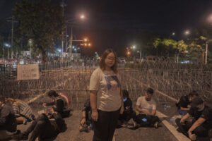 Panusaya Sithijirawattanakul, known as Rung, is a 22-year-old Thammasat university student and pro-democracy activist who is one of the pioneers calling for structural reform of society and monarchy in the 2020-2021 movement. Rung has been prosecuted on multiple and severe criminal offences, including sedition,, violations of the Emergency Decree and Computer Related Crime Act, organising illegal assemblies, allegedly threatening officials, and insulting the monarchy. Nine allegations have been pressed against her in relation to Rung’s critique of; the monarchy, the monarchy’s status under the 2017 Constitution Law, the monarchy’s private army, the monarchy’s fiscal and activities interfering with the state’s sovereignty, and the rule of law. Rung faces punishment of up to life imprisonment i The youth reform movement held mass, overwhelmingly peaceful protests and flash mobs during 2020 and into 2021 for political, constitutional and educational reform, LGBTQI equality and women’s and children’s rights. After protesters publicly discussed calls for reform to the monarchy, authorities detained and charged dozens of peaceful protesters.