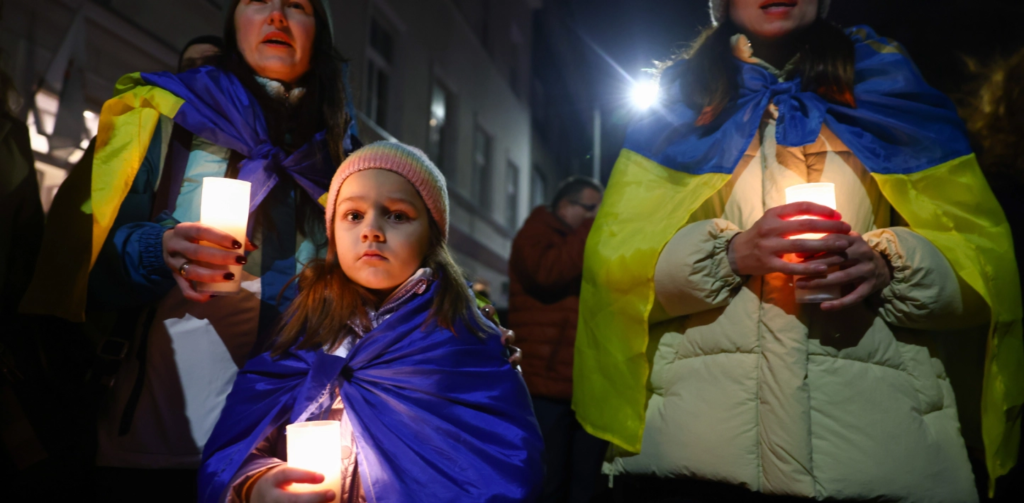 Women hold a vigil for those who have died during the war in Ukraine