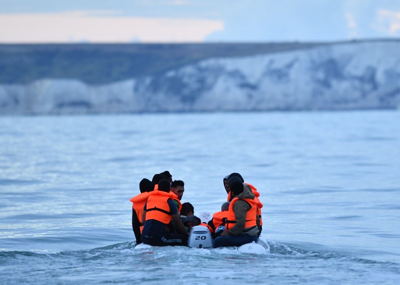 Migrants in a dinghy sail in the Channel toward the south coast of England on September 1, 2020 after crossing from France. - Migrant crossings of the Channel between France and England have hit record numbers, with thousands having arrived in small boats since the beginning of the year. The issue is politically-charged in the UK, with the country's right-wing newspapers decrying the arrivals and many ruling Conservative lawmakers calling for tougher border enforcement. (Photo by Glyn KIRK / AFP) (Photo by GLYN KIRK/AFP via Getty Images)