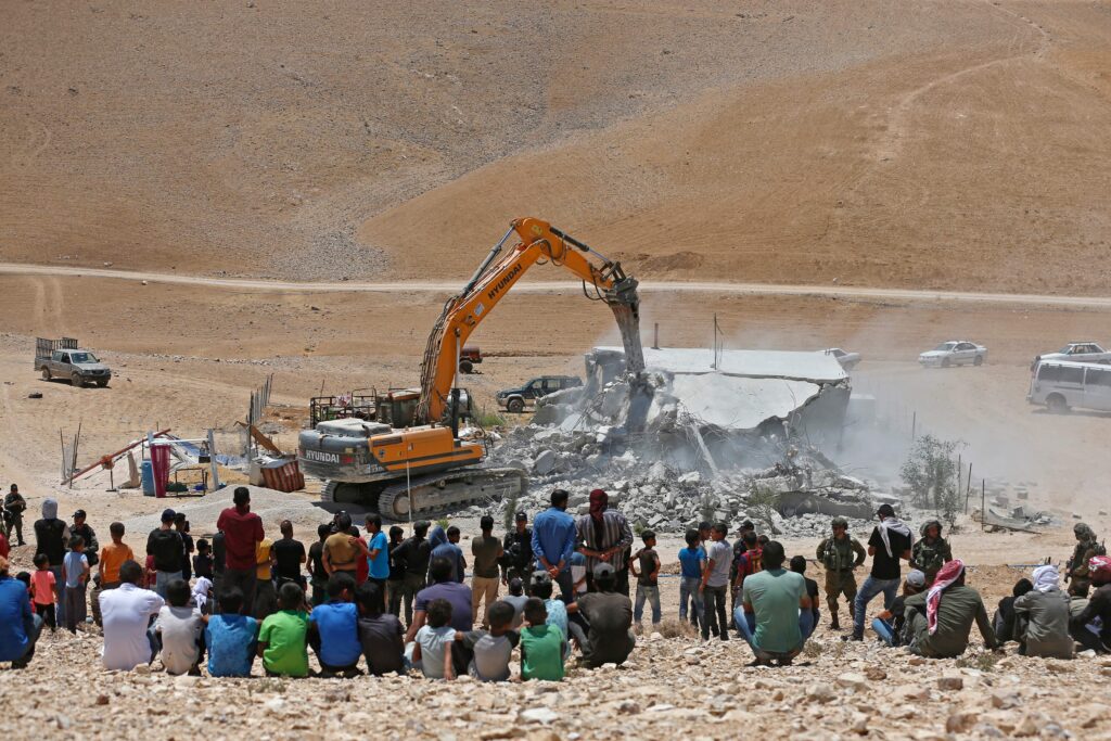 A Hyundai excavator carrying out demolitions in Masafer Yatta