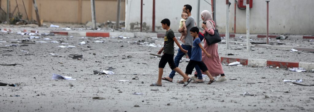 Palestinians inspect the massive destruction from Israeli airstrikes in Gaza City's al-Rimal district, on October 10, 2023.