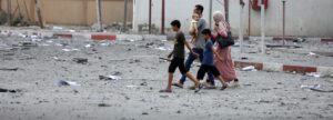 Palestinians inspect the massive destruction from Israeli airstrikes in Gaza City's al-Rimal district, on October 10, 2023.