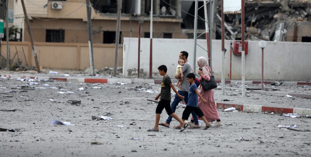 Palestinians inspect the massive destruction from Israeli airstrikes in Gaza City's al-Rimal district, on October 10, 2023