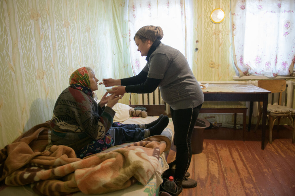 Krasnopilla, Sumy region in Ukraine, 7 November, 2023. Strybak Ludmyla social worker with Sidova Evgenia, 91 years old lady.