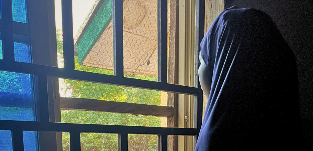 Nigerian woman looking out a window